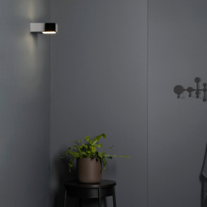 Kappa LED vägglampa sitter på en badrumvägg.