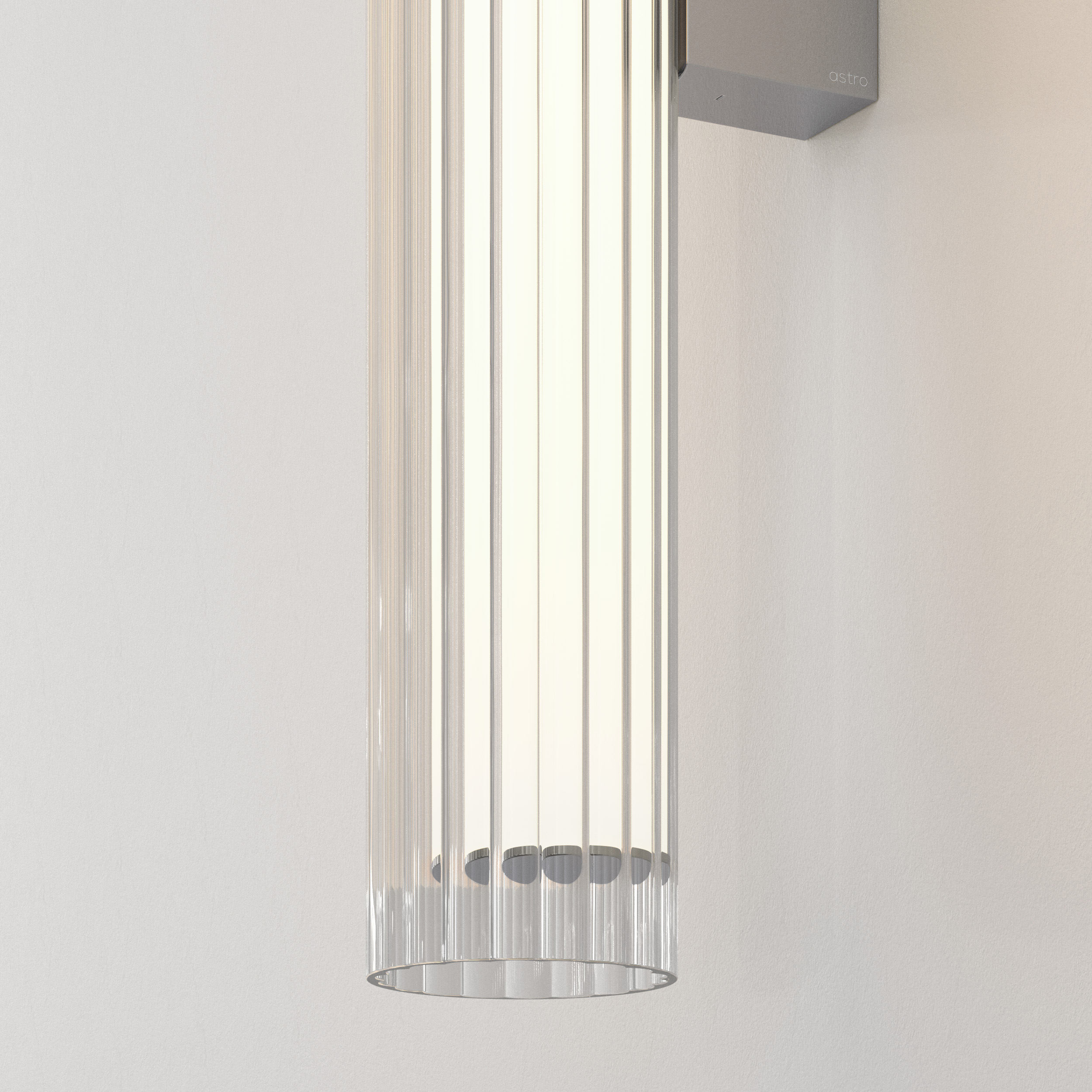 io 665 vägglampa i glas i en cyliderform.
