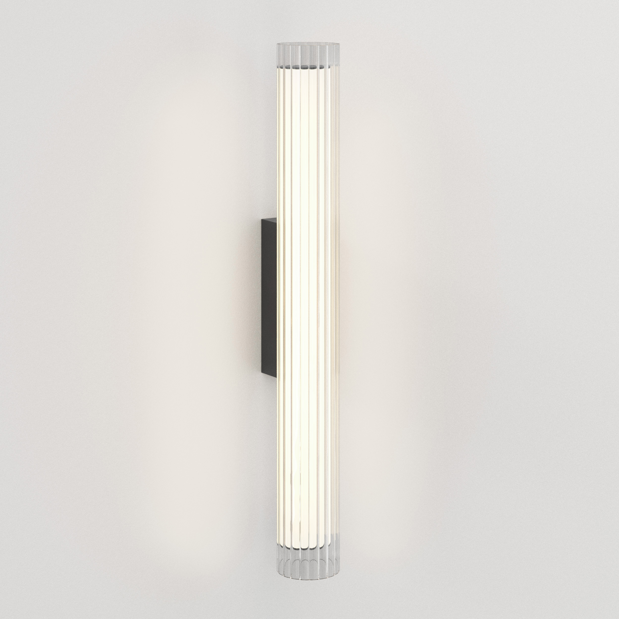 io 665 vägglampa i glas i en cyliderform.