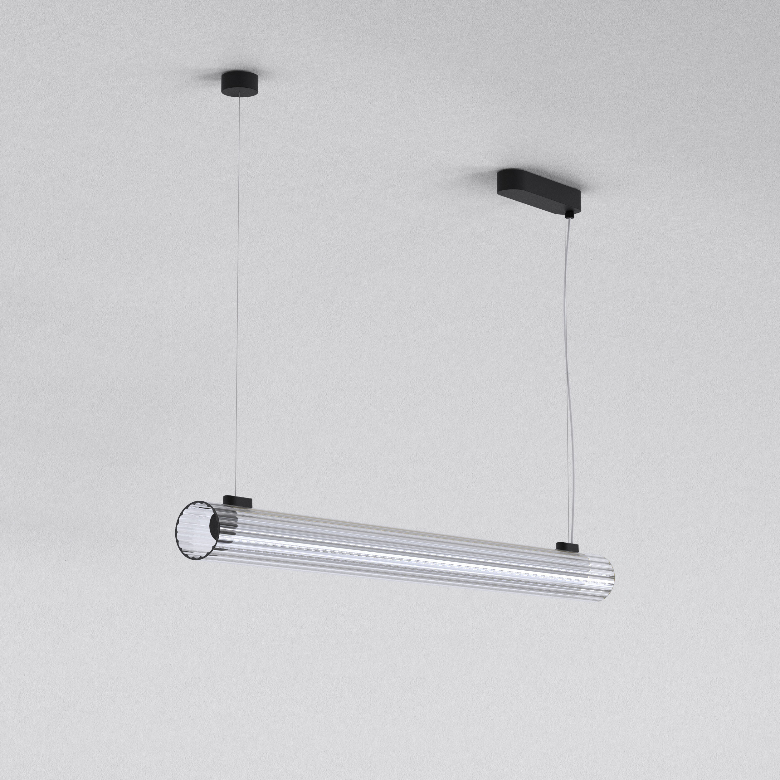 io Pendant 1000 taklampa, är en cylinderformad lampa som hänger från taket i två stållinor.