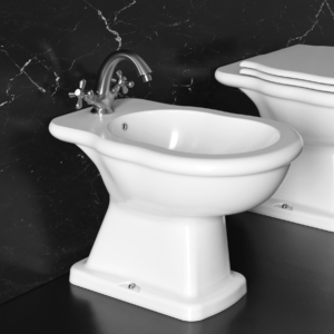 Classic golvstående bidé vid en toalett.