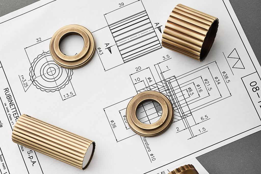 Delar av en Ennio-blandare från märket Stella som ligger på en ritning